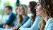 © Евгений Архипов - Medium close-up of a business lady taking notes during a meeting, with colleagues blurred in the background.
