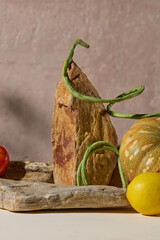 Autumn season abstract background pumpkin and cowpea decorated with blocks of stone on rustic background. Creative photo for advertising, space for display product