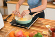 © Prathankarnpap - Cropped shot of young woman wearing active ware frying eggs for breakfast in kitchen
