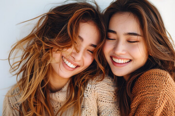 Two women smiling and hugging