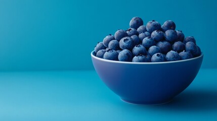 Bright blue bowl filled with fresh blueberries.