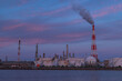 © pespiero - 日本　三重県四日市市の四日市コンビナートの煙をあげる煙突と夕焼け空
