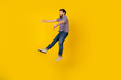 © deagreez - Full length body photo of young adult funky energetic man jumping open arms ready for hugs with everyone isolated over yellow color background