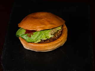 Cheese burger with bacon on black background