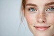 © Anna - Close-up of smiling woman with blue eyes and freckles