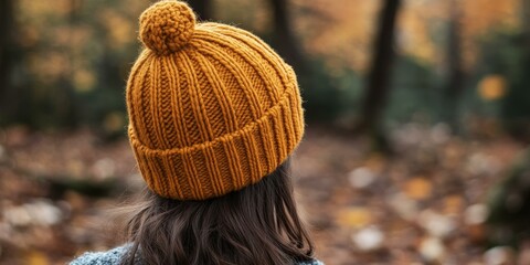 Canvas Print - A woman wearing a brown knit hat outdoors.