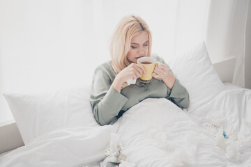 Poster - Photo of pretty young woman feel bad drink tea silky pajama white interior bedroom apartment indoors