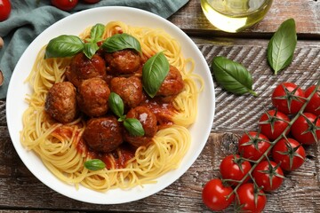 Sticker - Delicious pasta with meatballs and ingredients on wooden table, flat lay