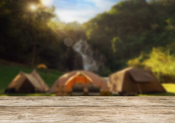 Wooden table top on camping ground mountain and grass field.Fresh and Relax concept.For montage product display or design key visual layout.View of copy space.