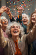 © Miljan Živković - mature senior woman friends have new year party with confetti