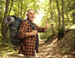 © Ljupco Smokovski - Smiling mature hiker with a backpack showing thumbs up
