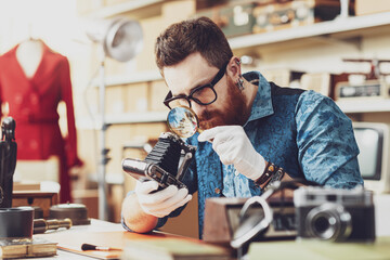 Wall Mural - Collector checking vintage items in his store