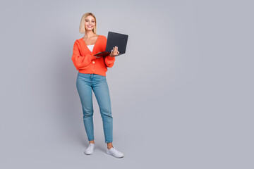 Poster - Full size photo of pretty young girl laptop empty space isolated on grey color background