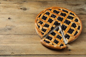 Poster - Tasty homemade pie with blueberries on wooden table. Space for text