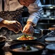© KimSrea - Chef adding final touches to a dish in upscale restaurant kitchen