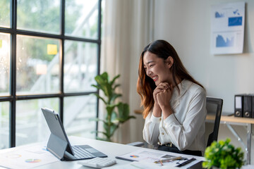 Wall Mural - asian businesswoman celebrating success looking at tablet computer screen