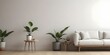 © Sharif54 - A minimalist living room with a white sofa, a wooden side table, and a potted plant.