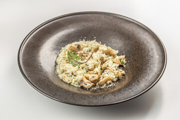 Canvas Print - delicious risotto with mushrooms in bowl. Rice porridge, italian cuisine. Menu, recipe mock up, banner. top view