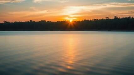 Poster - Golden hour sunset over a tranquil lake.