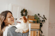 © KDdesignphoto - Portrait of adorable, happy smiling dog of the corgi breed. New Year's holiday atmosphere. Beloved pet in the beautiful home.