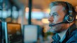 © liliyabatyrova - A man wearing a headset is sitting in front of a computer monitor
