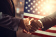 © julia_aldo - Business handshake with American flag in background, formal partnership agreement