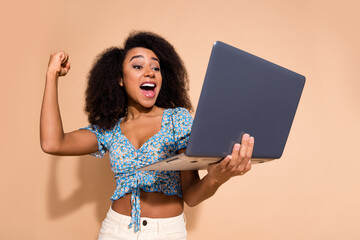 Wall Mural - Photo of adorable lovely girl wear blue top winnin game modern device empty space isolated beige color background