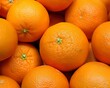 © Yuliia - vibrant and detailed close-up of fresh oranges piled together, showcasing their bright orange skin and texture. Ideal for food, health, or citrus-related designs that emphasize freshness and natural g