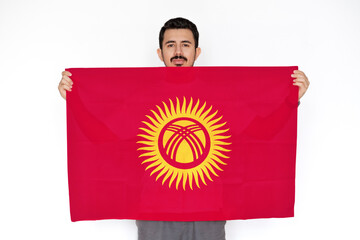 young man holding kyrgyzstan flag, independence day idea, two hands and white background