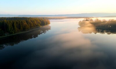 Canvas Print - Fog rolling over a calm lake at dawn.  Video