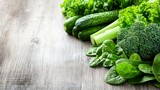 Fresh green vegetables like broccoli, spinach, lettuce, and cucumbers on a rustic wooden table, promoting healthy eating and organic produce.