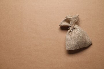 Wall Mural - One burlap sack on beige background, top view. Space for text