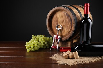 Poster - Wing corkscrew, corks, bottles of wine, grapes and barrel on wooden table