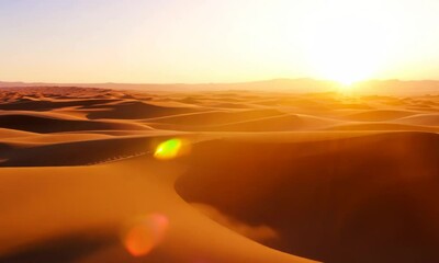 Poster - Sunset casting a warm glow over a desert landscape.  Video