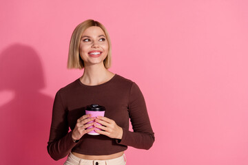 Poster - Photo of lovely pretty cute girl wear trendy brown clothes hold tasty coffee empty space isolated on pink color background