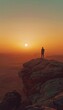 © spyrakot - Solitude and Freedom: Lone Figure on Rocky Outcrop at Sunset in Vast Desert Landscape