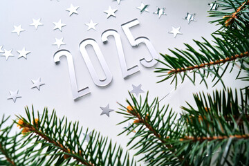 Wall Mural - abstract light christmas background with stars and a christmas tree with the year number 2025.