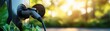 © Rossarin - Close-up of an electric vehicle charger plugged in, surrounded by greenery, symbolizing clean energy and sustainability.