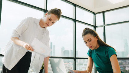 Wall Mural - Smart businesswoman present start up project while executive manager listen carefully. Professional business team working together, sharing, discussing, thinking about business idea. Tracery