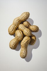 Wall Mural - Oil painting depicting a cluster of raw peanuts against a white background