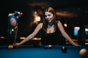 Wall Mural - A young female with a focused expression aiming at pool balls on a billiard table with a dart game in the background.