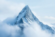 © barmaleeva - Snow covered mountain peak rises above clouds