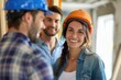 © Nognapas - Young smiling couple and handyman talking about details of renovations home