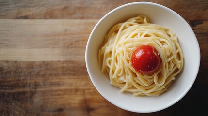 Canvas Print - white ceramic bowl with pasta and red tomato on brown wooden table