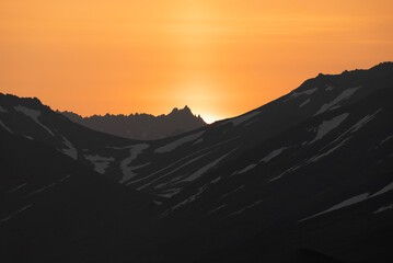 Stunning sunset over mountains and sea on wild natural islands in the northern region of the world, a journey to the cold and fiery sunsets of nature