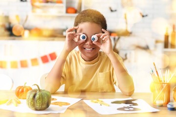 Poster - African-American boy making Halloween decorations at home