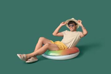 Sticker - Young man with swim ring on green background