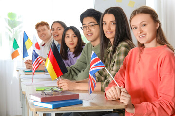 Wall Mural - Young students with flags at language school