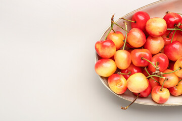 Canvas Print - Bowl with sweet yellow cherries on grey background