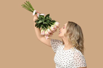 Poster - Happy young woman with bouquet of beautiful roses on brown background